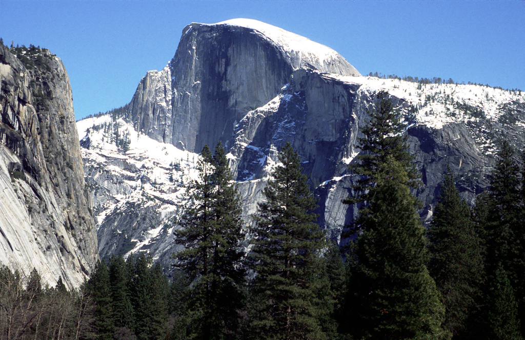 The view of the gripping Half Dome peaking out from the surrounding mountains at Yosemite National Park